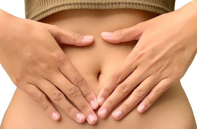 woman placing hands on stomach